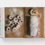 Open book showing a page with images of pastries on a white background