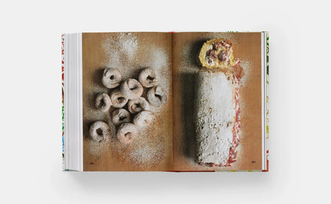 Open book showing a page with images of pastries on a white background