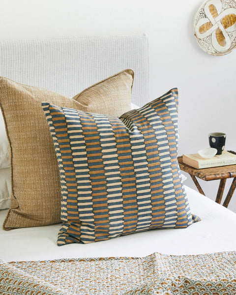 Khan Desert pillow layered with coordinating pillows