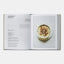 Open cookbook showing a recipe for mushroom risotto with an image of the dish on a white background.