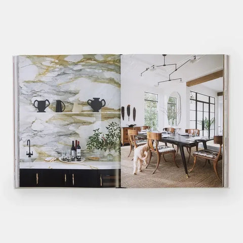 Open book showing a marble countertop with vases and a dining room with a dog.