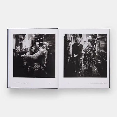 Open book showing black and white photographs of people in a room.