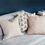 Sula Rose pillow layered with coordinating pillows