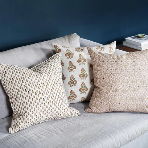 Sula Rose pillow layered with coordinating pillows