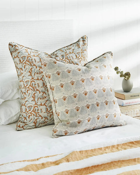 Avignon Sahara pillow layered with coordinating pillows