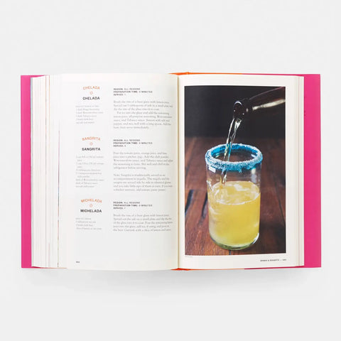 Open book with a page showing a cocktail being poured into a glass.