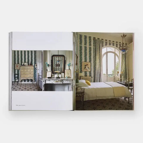 Open book showing a bedroom interior with green patterned wallpaper and a bed.