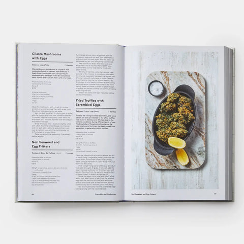 Open cookbook showing a recipe for Nori Seaweed and Egg Fritters with a photo of the dish on a marble surface.