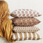 Kesula Moonflower pillow layered with coordinating pillows