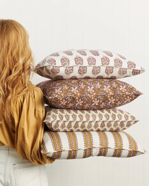 Kesula Moonflower pillow layered with coordinating pillows